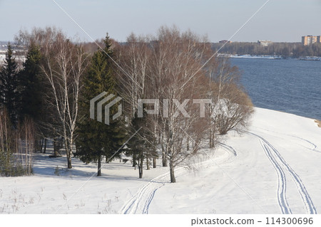 river on a sunny evening. Trees and shrubs. Landscape of winter nature, river banks  114300696
