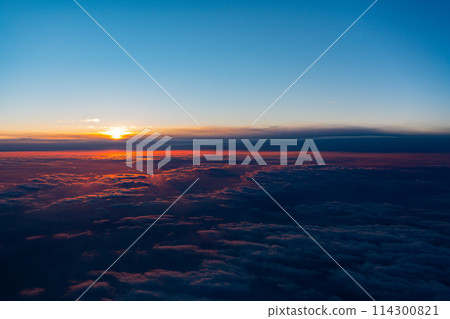 In-flight resort engine sightseeing travel airplane sea wing seat inbound window sunrise sunset 114300821