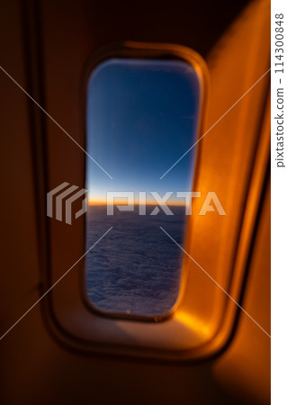 In-flight resort engine sightseeing travel airplane sea wing seat inbound window sunrise sunset 114300848