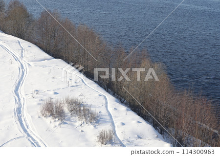 river on a sunny evening. Trees and shrubs. Landscape of winter nature, river banks  114300963