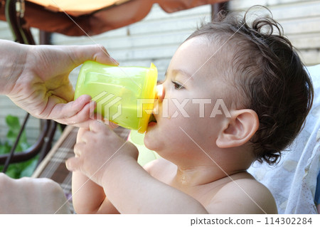children eating healthy food at home or kindergarten. Happy toddler boy drinking white kefir 114302284