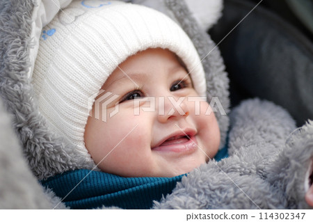 Happy little baby boy making outdoors in winter. Cute toddler in winter cloth. Child having fun on cold day. Winter walk outdoors Happy little baby boy making outdoors in winter. Cute toddler in winter cloth. Child having fun on cold day. Winter walk outdoors 114302347