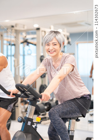 Senior woman exercising at the gym Senior woman exercising at the gym 114302673