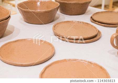 Dad and son in the front seat of a car driving a black car 114303813