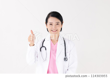 Middle-aged woman in white coat thumbs up Middle-aged woman in white coat thumbs up 114303955