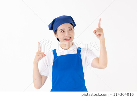 Middle-aged woman, uniform, apron, pointing 114304016
