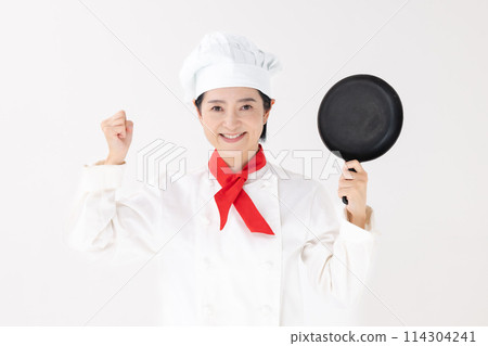 Middle-aged woman in chef's uniform giving a fist pump Middle-aged woman in chef's uniform giving a fist pump 114304241