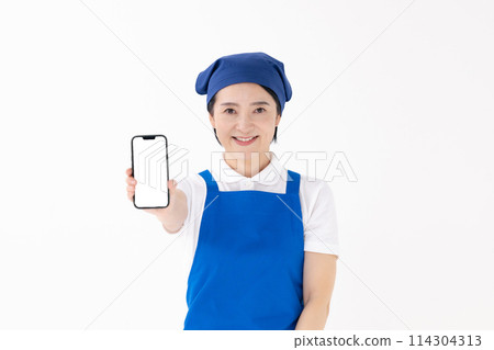 Middle-aged woman, uniform, apron, smartphone 114304313