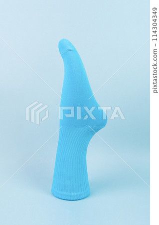Blue cotton volumetric sock on blue background. advertising, logo, branding. 114304349