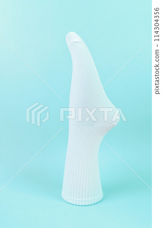 white cotton socks on blue background. advertising, logo, branding. white cotton socks on blue background. advertising, logo, branding. 114304356