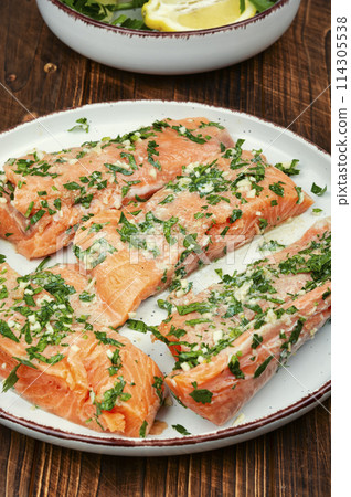 Tasty raw marinated salmon fish. Tasty raw marinated salmon fish. 114305538