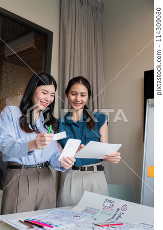 ux developer and ui designer presenting mobile app interface design on whiteboard in meeting at office. Creative digital development mobile app agency. digital transformation 114309080