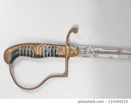 A silver and gold sword with a black handle A silver and gold sword with a black handle 114309233