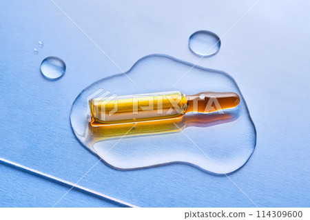 Ampoules in liquid on a blue background. Ampoules in liquid on a blue background. 114309600