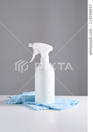 Cleaning product with a sprayer on a background of a blue microfiber cloth. 114309657