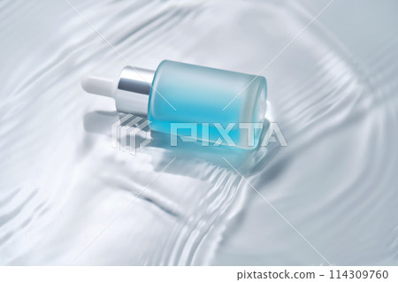 Bottles of cosmetics with a dropper in water on a blue background. 114309760