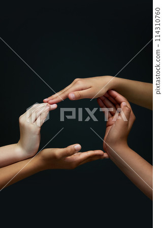 One whole. Diverse children's hands making circle against black background. Racial equality spirit. Unity. 114310760