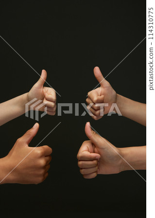 Like. Divers children's hands showing thumb up, symbolizing congratulate winner against black background. Like. Divers children's hands showing thumb up, symbolizing congratulate winner against black background. 114310775
