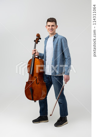Attractive man musician playing cello on concert Attractive man musician playing cello on concert 114311064
