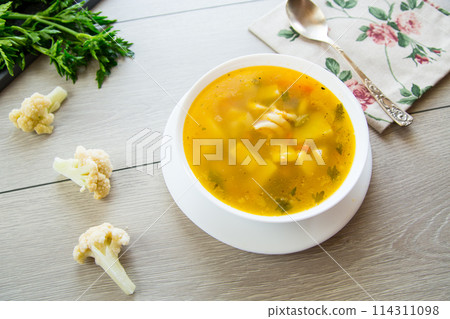 Homemade chicken vegetable soup on rustic wooden background 114311098