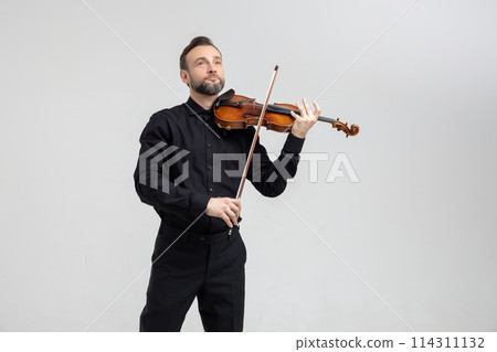 Elegant musician man violinist playing on concert 114311132
