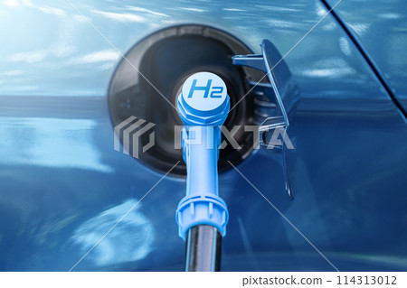 Close up of fuel cell car with connected hydrogen fueling nozzle. 114313012
