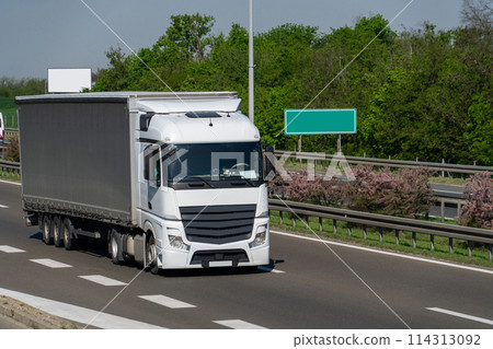 Semi truck with trailer on the highway 114313092
