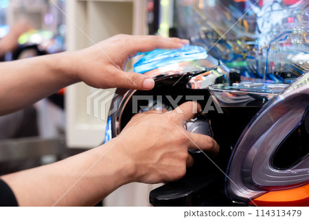 Man playing pachinko 114313479