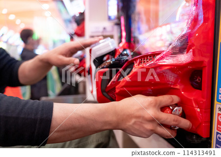 Man playing pachinko Man playing pachinko 114313491