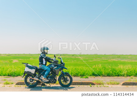 Bike riding through the grassland 114314434