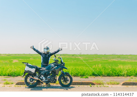 Bike riding through the grassland Bike riding through the grassland 114314437