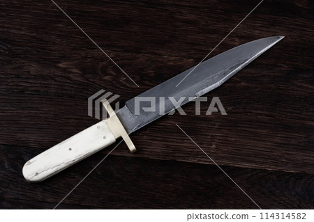 Old west bowie knife on wooden deck Old west bowie knife on wooden deck 114314582