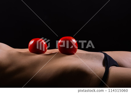 Female with tomatoes on her chest and back, concept of healthy food and female health 114315060