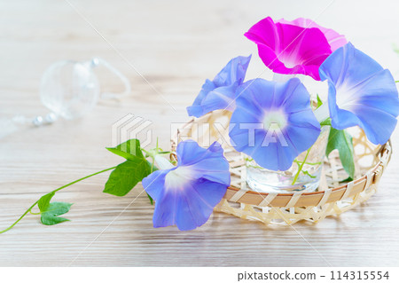 Morning glory flower arrangement and glass wind chimes background 114315554
