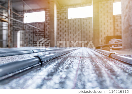 Installation of underfloor heating pipes of a heating system at the rough finishing stage for efficient heating of the room. 114316515