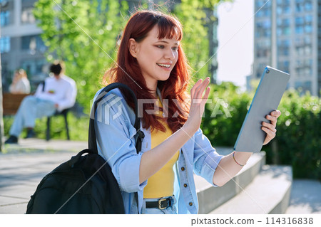 Young female college student using digital tablet outdoor Young female college student using digital tablet outdoor 114316838