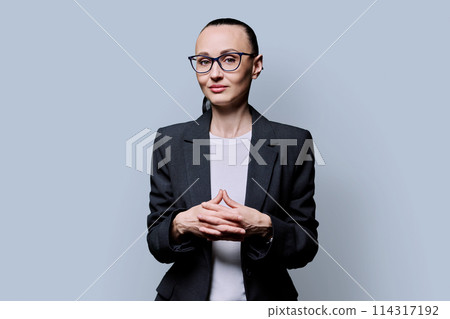 Portrait of thinking serious confident business woman , on grey studio background 114317192