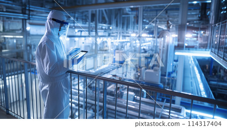 Man in White Coverall Standing in Factory 114317404