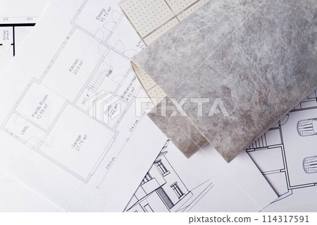 Laying flooring. Linoleum, a knife and a house plan on the builder's table. Taking measurements for laying the floor. Laying flooring. Linoleum, a knife and a house plan on the builder's table. Taking measurements for laying the floor. 114317591