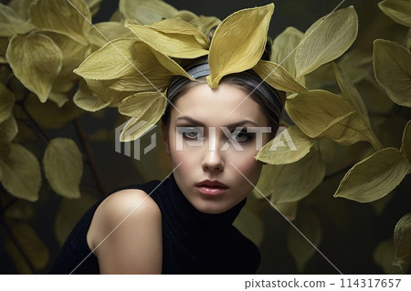 Surreal Closeup Portrait of an attractive young woman, a lot of levitating luminous leafs 114317657