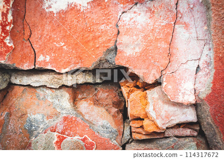 Old wall with deep cracks. Texture of stone and broken concrete. Grunge texture of ruined wall. Old wall with deep cracks. Texture of stone and broken concrete. Grunge texture of ruined wall. 114317672