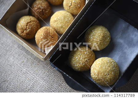 Sweet sesame cookies in cardboard boxes on burlap. Cookies in a box. 114317789