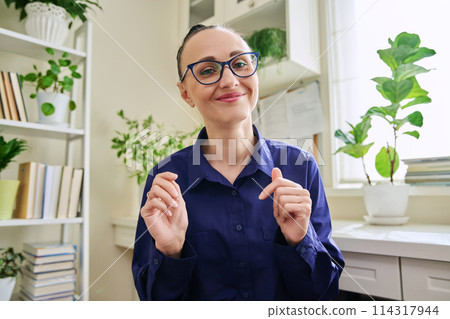 Webcam view of smiling 30s woman talking looking at camera 114317944