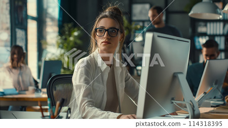Woman Using Laptop at Table Woman Using Laptop at Table 114318395