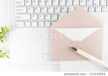 A computer, an envelope, and letter paper. Image of writing an email 114318956