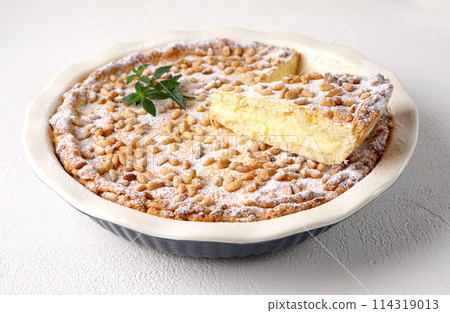 Rhubarb custard tart or pie in ceramic form on the table. Summer healthy dessert. Selective focus 114319013