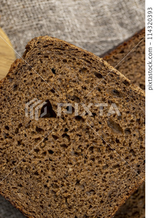 rectangular loaf of bread on a linen cloth rectangular loaf of bread on a linen cloth 114320393