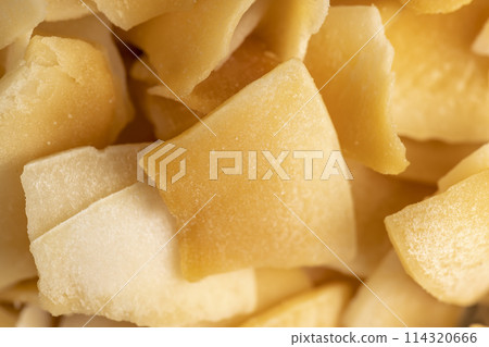 sweet orange and yellow coconut flakes fried in sugar 114320666