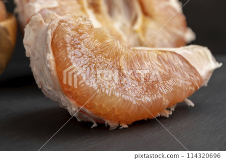 peeled red and pink pomelo on the table 114320696
