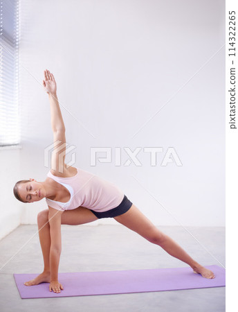 Fitness, yoga and stretching with woman on mat in studio for awareness, mindfulness or wellness. Exercise, health and pilates with young yogi in position to relax for zen, balance or inner peace 114322265